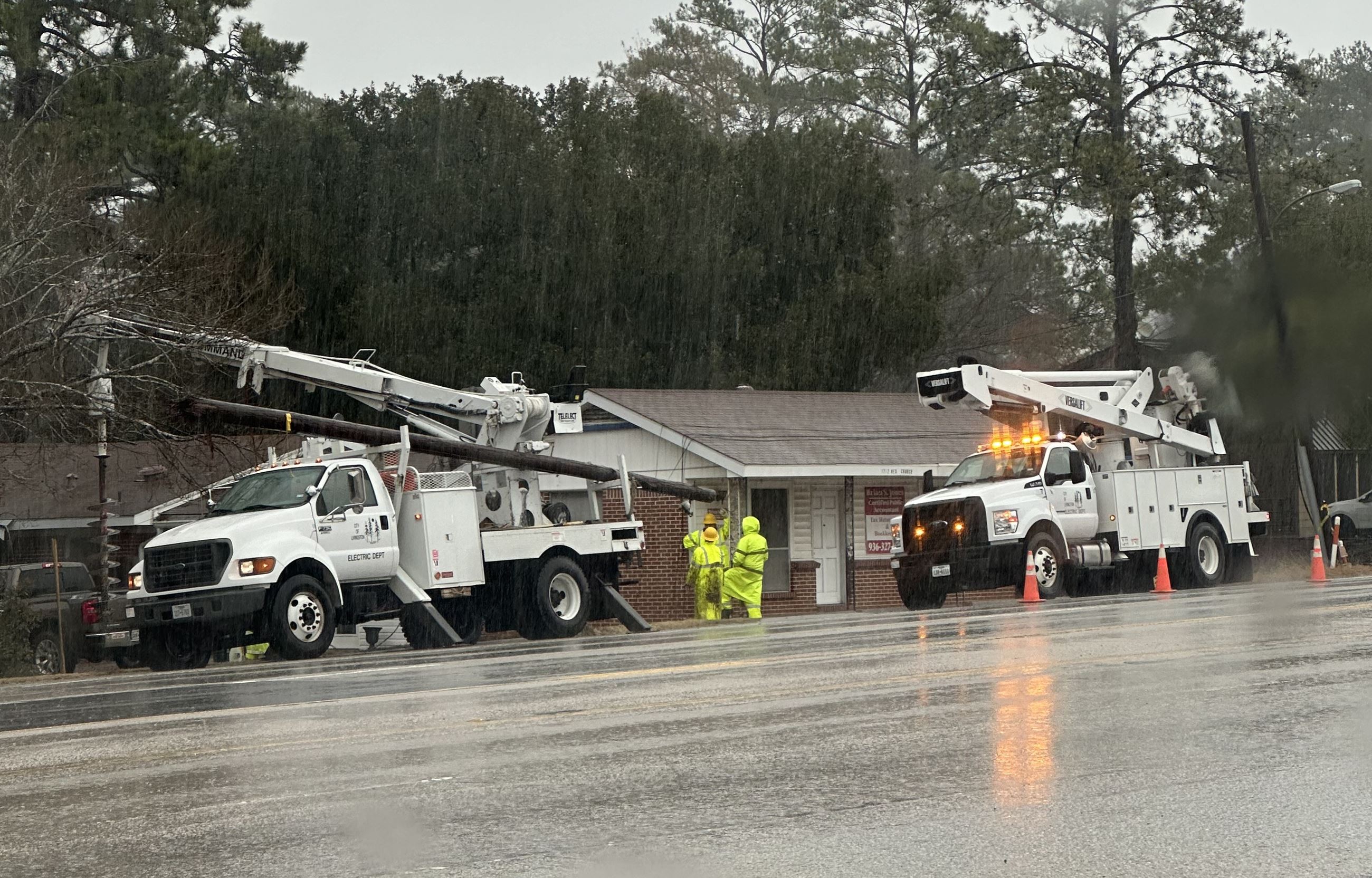 Electric Department changing out pole during rain